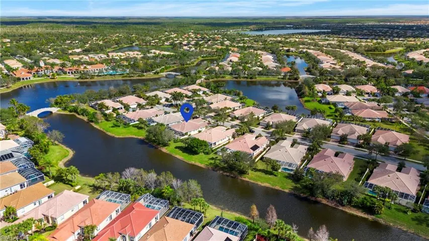 Birds eye view of property with a water view
