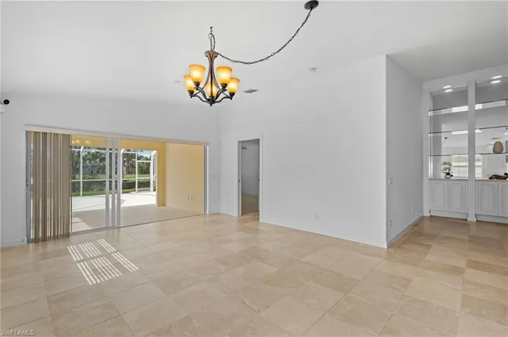 Unfurnished room with a chandelier