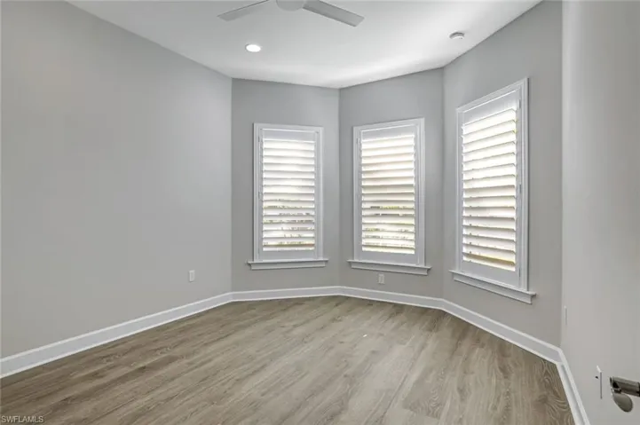 Spare room with wood finished floors, recessed lighting, and ceiling fan