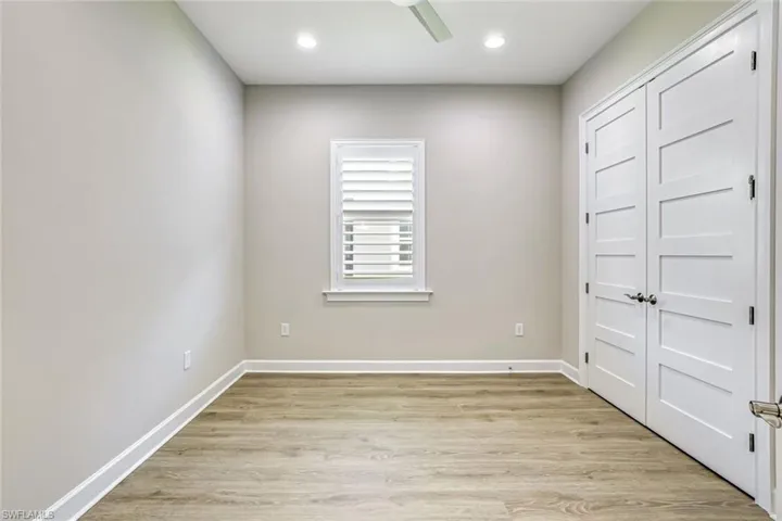 Unfurnished bedroom featuring a closet, light wood-type flooring, a ceiling fan, and recessed lighting