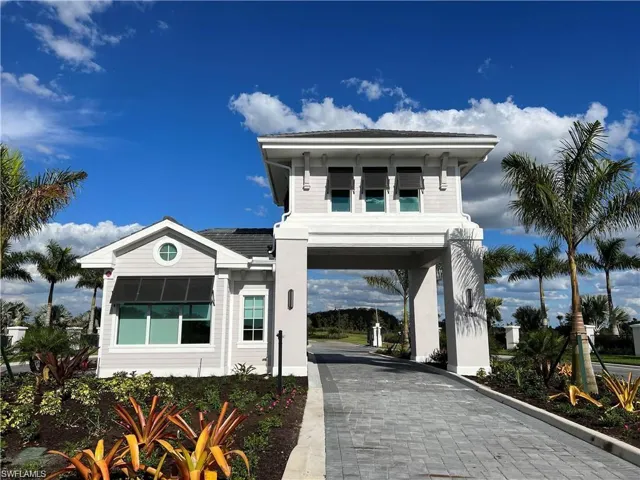View of front facade with decorative driveway and a carport