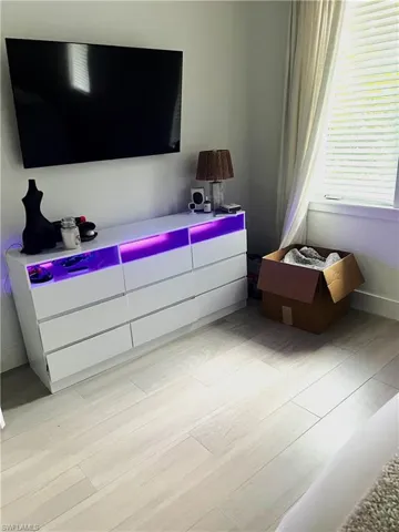 Bedroom featuring light wood-type flooring and baseboards