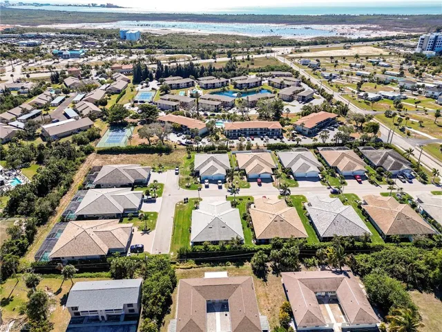 Aerial view of property and surrounding area featuring nearby suburban area