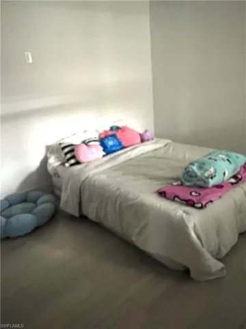 Bedroom with wood finished floors