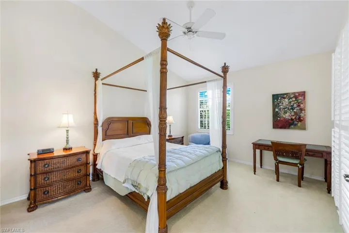 The primary bedroom, located just off the living room, with ensuite bathroom and access to the screened lanai.