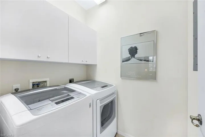 Dedicated laundry room with newer LG washer and dryer.