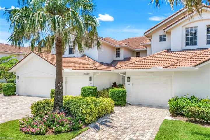 Charming curb appeal with lush landscaping and a private one-car garage.