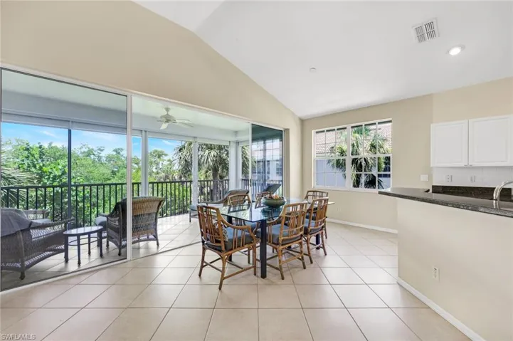 Open dining area with direct access to the screened balcony.