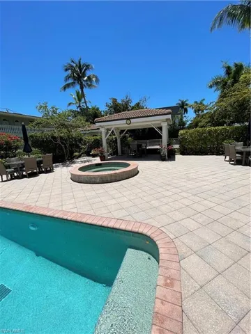 View of swimming pool with a patio, an in ground hot tub, and a gazebo