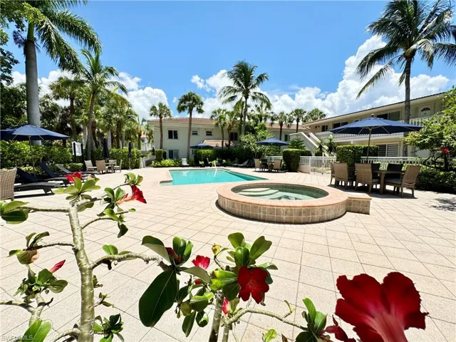 View of pool with an in ground hot tub and a patio area