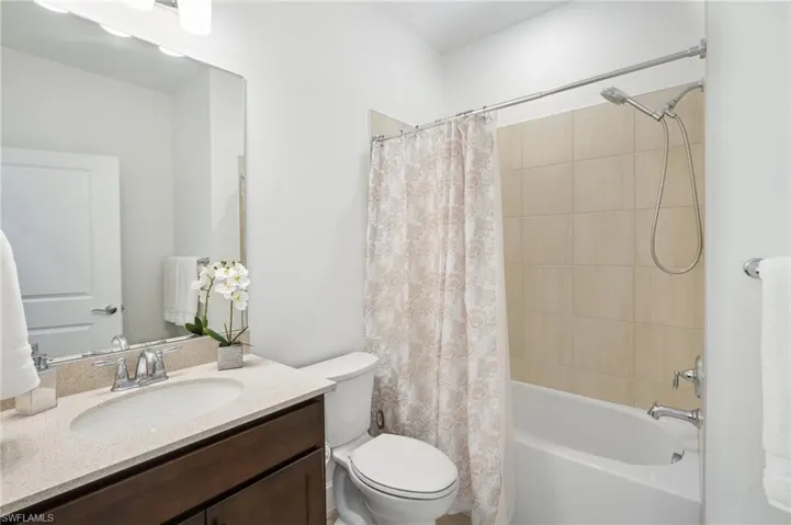 Full bathroom featuring shower / bath combo, vanity, and toilet