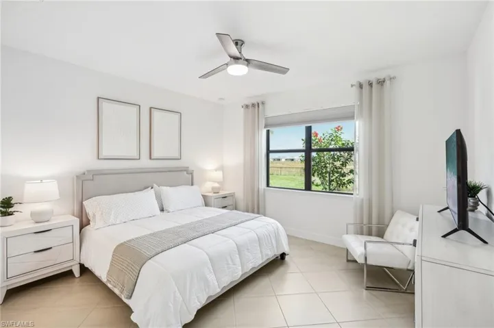 Bedroom with ceiling fan and light tile patterned flooring