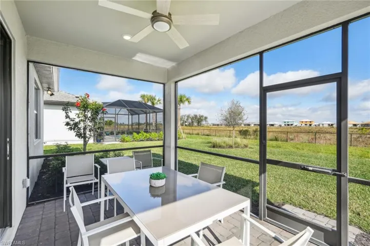 Sunroom / solarium featuring ceiling fan