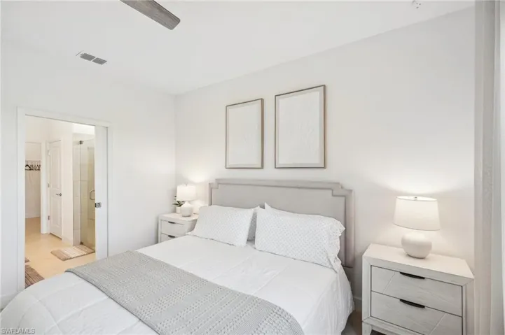 Bedroom with ceiling fan and ensuite bath