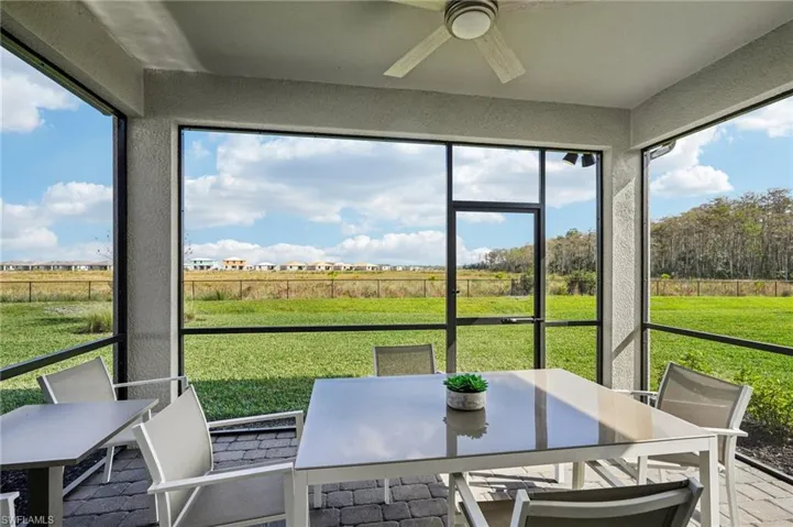 Sunroom featuring a rural view and ceiling fan