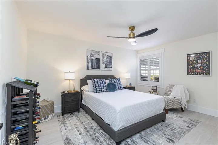 Bedroom with light wood-type flooring and a ceiling fan