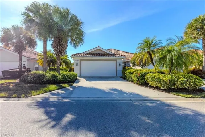 View of front of house with concrete driveway, an attached garage, and a tile roof