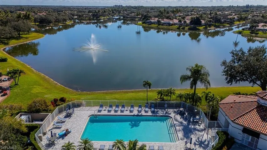 Drone / aerial view of a pool and a large body of water