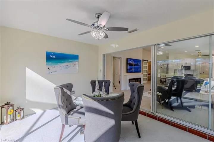 Office space with ceiling fan and a fireplace