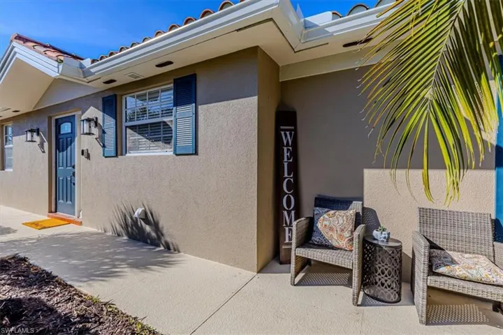 Doorway to property featuring stucco siding and a tiled roof