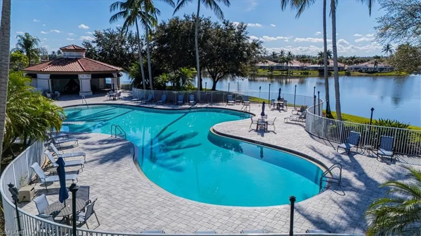 Community pool with a patio, a gazebo, and a water view