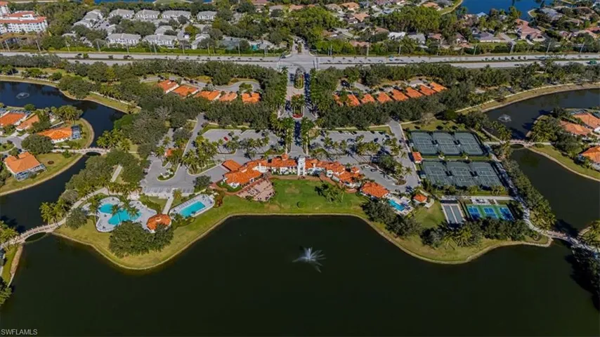 Aerial view of property and surrounding area with a nearby body of water and nearby suburban area