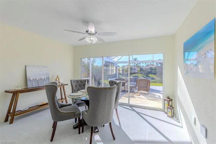 Dining space with a sunroom and a ceiling fan