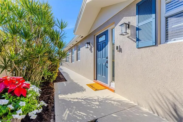 Property entrance featuring stucco siding