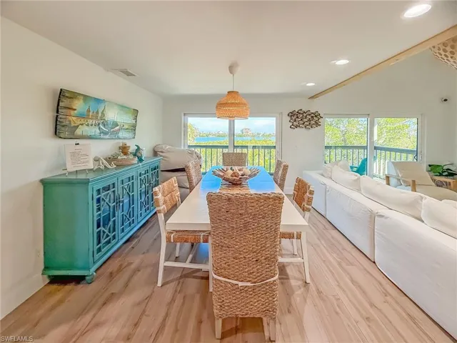 Dining room with a healthy amount of sunlight and light hardwood / wood-style flooring