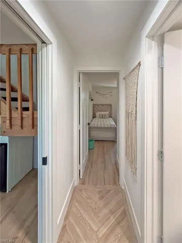 Hall with light hardwood / wood-style flooring