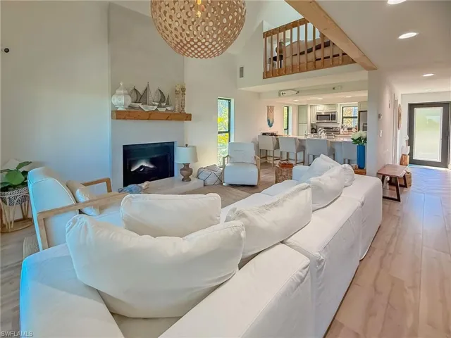 Living room with a towering ceiling and light wood-type flooring