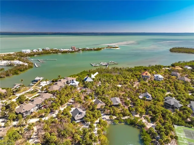 Birds eye view of property with a water view