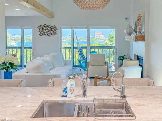 Living room featuring a fireplace and sink