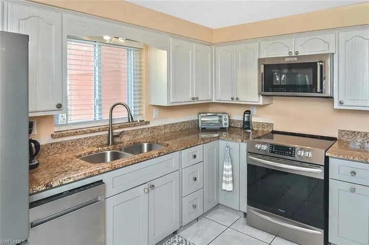 ...two-toned cabinetry and granite countertops...