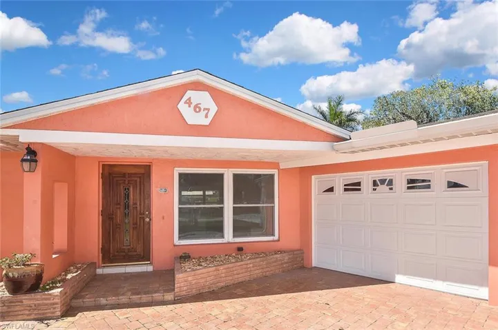 Painted in the cheerful and sunny color of the tropics, this home beckons: Come on in!