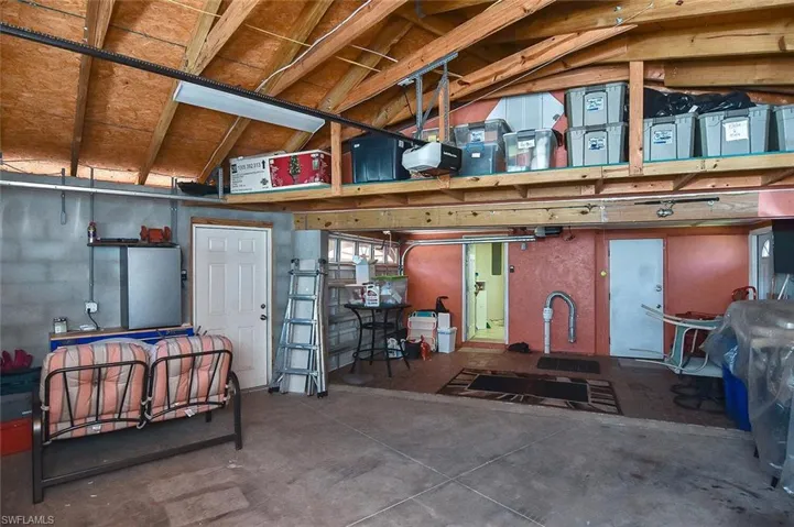 ...while the recently-expanded garage space offers rafter storage in addition to the separate storage room (door on right).