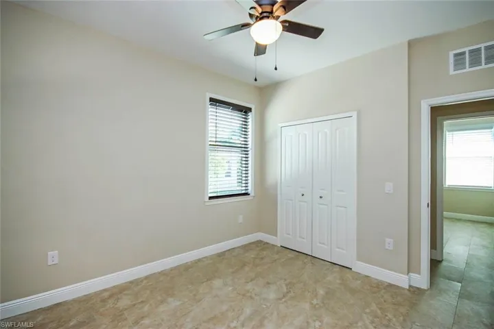 Unfurnished bedroom featuring a closet and a ceiling fan