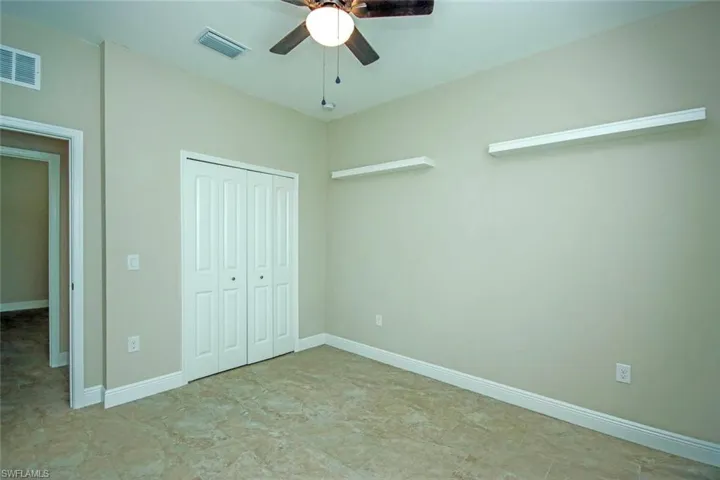Unfurnished bedroom featuring a closet and ceiling fan