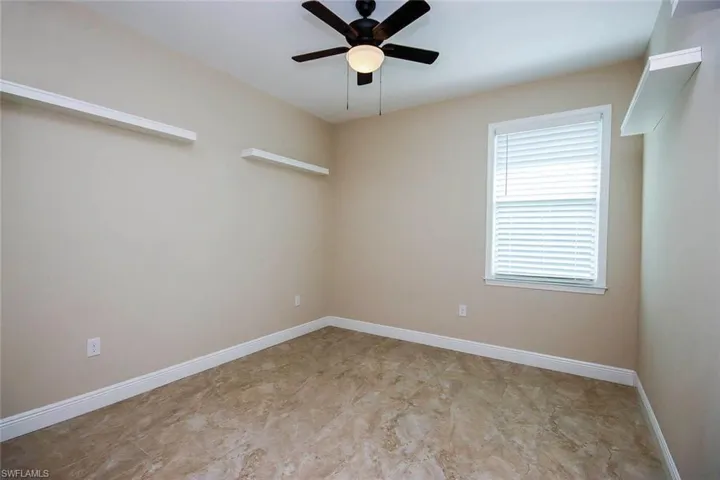 Spare room featuring baseboards and a ceiling fan
