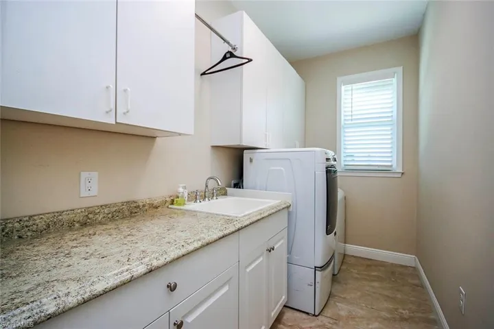 Laundry room featuring washer / clothes dryer and cabinet space