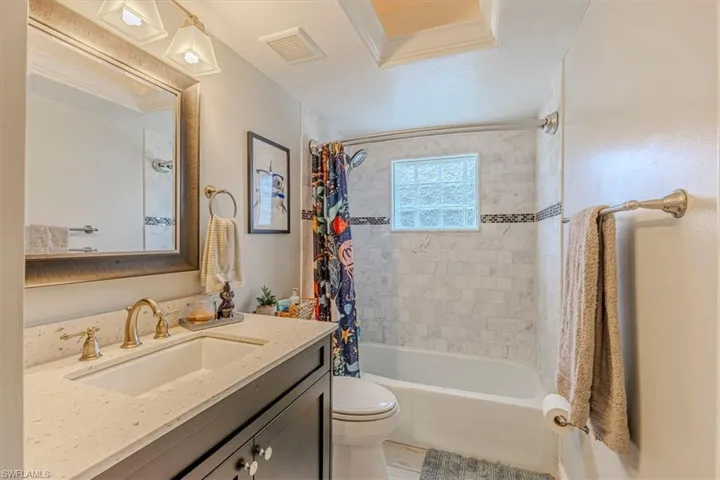 Bathroom featuring vanity and shower / tub combo