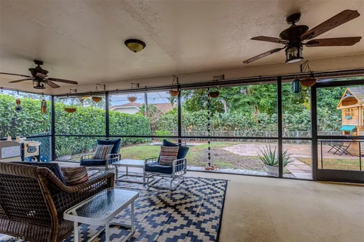 Sunroom / solarium with ceiling fan and an outdoor hangout area