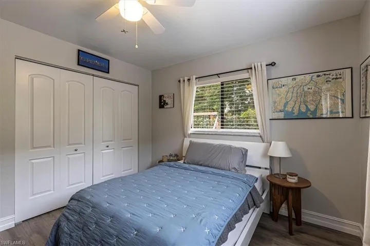 Bedroom featuring wood finished floors, a closet, and a ceiling fan