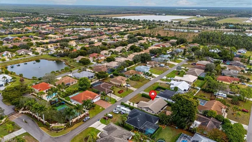 Aerial view of property and surrounding area featuring a large body of water and nearby suburban area