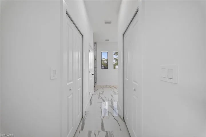 Bedroom with ceiling fan, recessed lighting, marble finish floors, and a tray ceiling