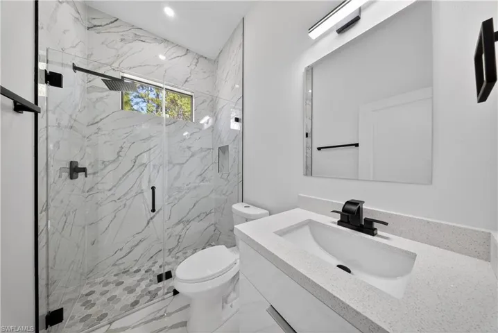 Unfurnished bedroom featuring ceiling fan and light marble finish floors