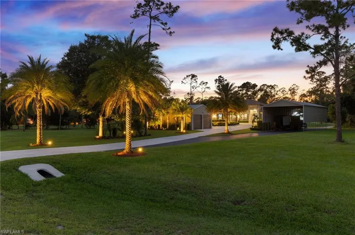 View of property's community with a lawn