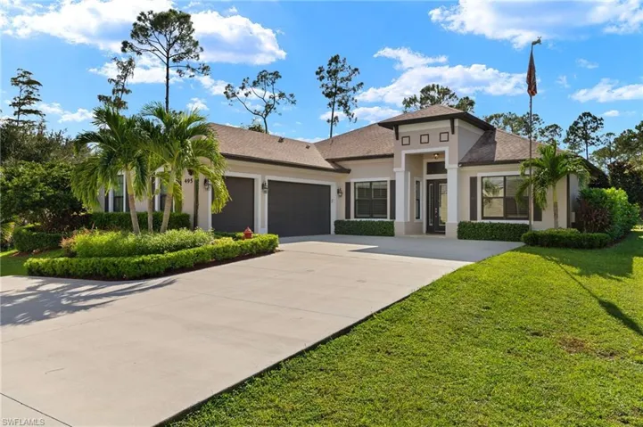 View of front of house featuring a front yard and a garage
