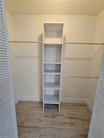 Guest Walk in closet featuring light hardwood / wood-style floors