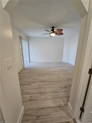 Corridor with light wood-type flooring